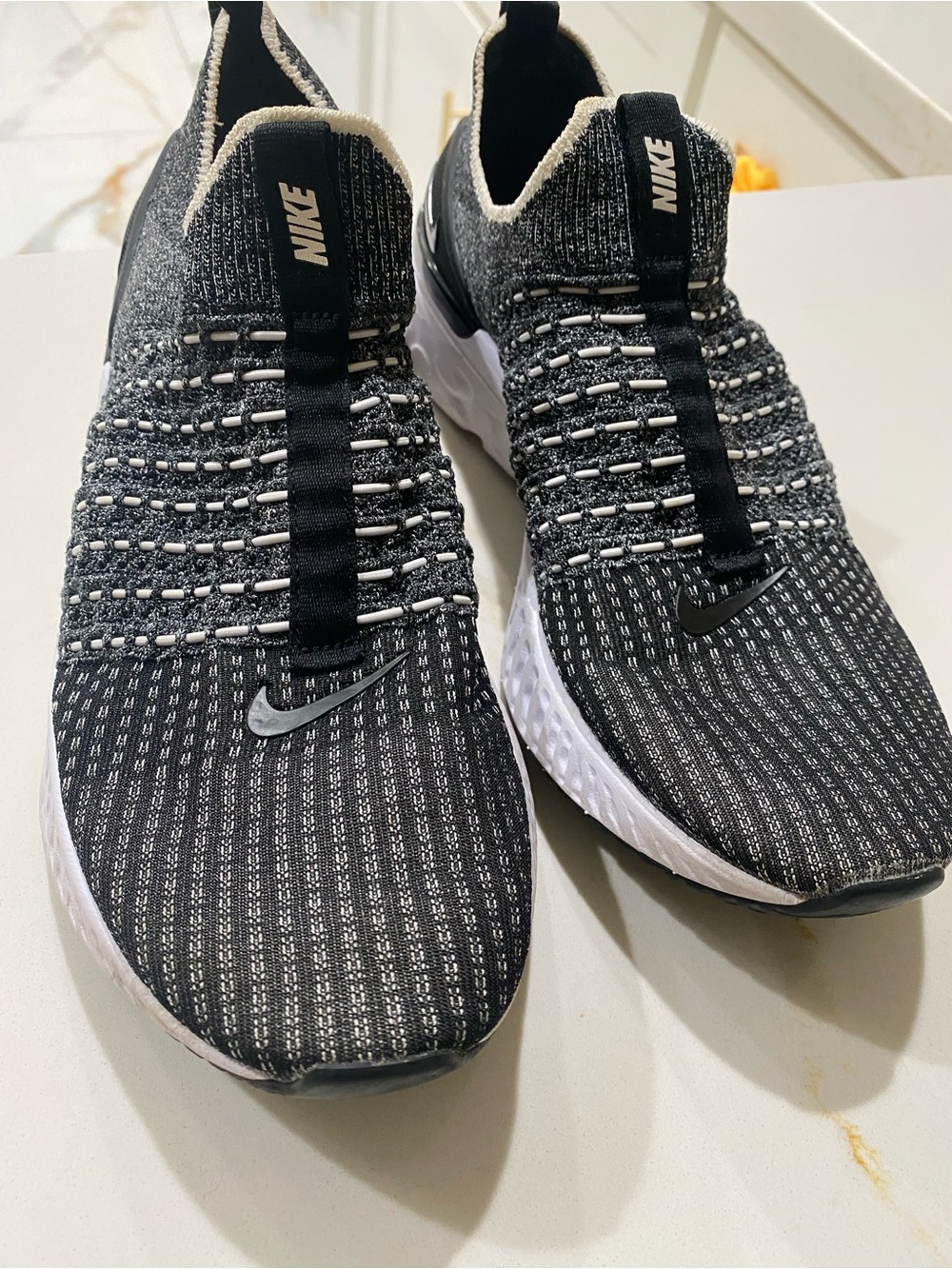 Nike Men’s Black and White Knit Slip-On Sneakers